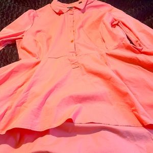 Coral colored Long sleeve button down shirt with High/Low Hem.